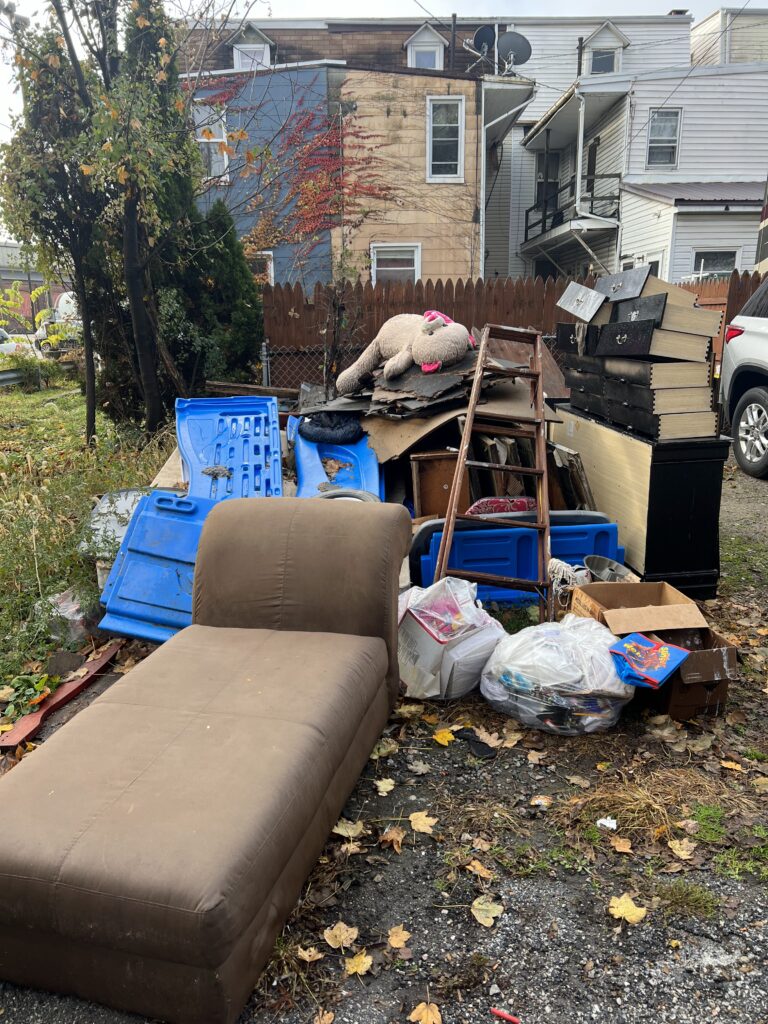 Before: a property buried in junk and debris ahead of a Wolfgang Hauling cleanout