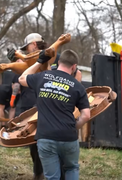 Wolfgang Hauling crew in branded shirts hauling demolition debris